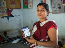 Community Health Worker using a phone